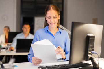 Poster - business, deadline and technology concept - businesswoman with papers and computer working at night office