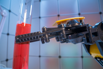 Wall Mural - Test tube in robot arm. robot manipulates chemical tubes in the laboratory