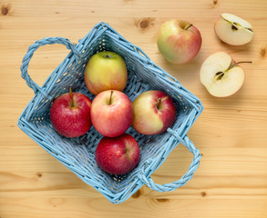 Red apples in blue wooden basket