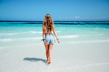 Fototapeta Na sufit - Young blonde woman on paradise beach blue ocean sea view