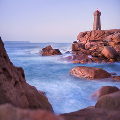 Wall Mural - rocks and blurred sea around lighthouse in France