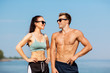 © Syda Productions - fitness, sport and lifestyle concept - happy couple in sports clothes and sunglasses on beach