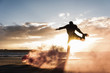 © Westend61 - Man doing movement training at the beach with colorful smoke at sunset