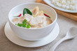 Chicken with coconut milk soup in bowl and rice on plate , Thai food (Tom Kha Kai).