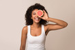 © Prostock-studio - Happy young woman holding half of grapefruit