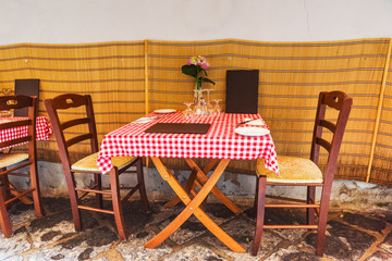 Wall Mural - Picturesque tables and chairs in a narrow alley in old town Sorrento