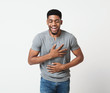 © Prostock-studio - Young african-american man laughing out loud in studio