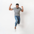 © Prostock-studio - Young black man jumping against white background
