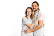 © A Stock Studio - Portrait of happy couple on white background. Couple man and woman hugging and looking at camera.