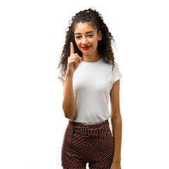 Young girl with curly hair showing and lifting a finger in sign of the best on white background