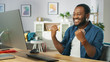 © Gorodenkoff - Happy Young Man Uses Personal Computer at Home, Wins Big, Does 'Yes' Gesture, Celebrates Victory Emotionally. In the Background Cozy Living Room.