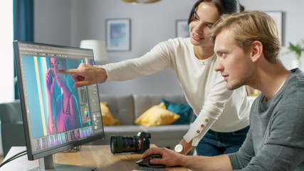 Male and Female Professional Editors Talk while Working in Photo Editing App / Software on a Personal Computer. Photo Editors Retouching Photos of a Beautiful Girl. Mock-up Software Design.