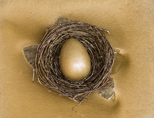 nest with golden easter eggs on a gold background