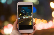 © Stocksy - close-up of hand holding smart phone at night