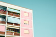 © Stocksy - Pink Pastel Building Pink pastel building with a colorful balconies and pastel sky background.