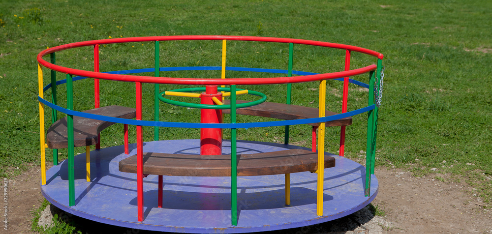 Children's iron carousel. Children's playground. Swing, carousel and ...