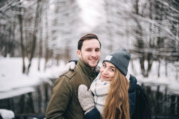 Wall Mural -  couple in love in the winter forest in the frost. Clothes in the cold season.