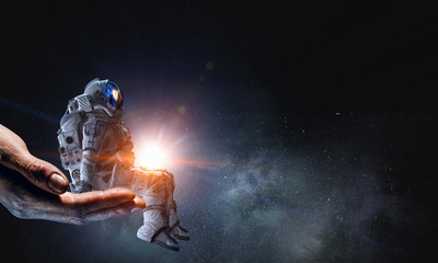 Wall Mural - spaceman on finger. mixed media