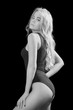 © tugolukof - beautiful young woman show her slim body on black background, monochrome