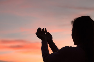 Silhouette of woman hands praying to god  Woman Pray for god blessing to wishing have a better life. begging for forgiveness and believe in goodness.