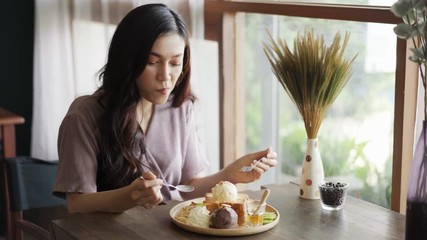 Wall Mural - young woman eating honey toast 