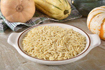 Canvas Print - Bowl of raw orzo with ingredients