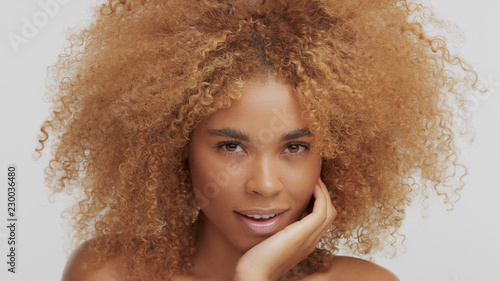 Mixed Race Black Blonde Model With Curly Hair Chin Down Watching