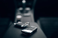 Car Keys Inside Automobile. Rental Service. Car Ignition Keys At The Armrest At The Modern Car Interior