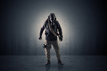 Wall Mural - Bad agent in a dark room with arms on his hand and gas mask
