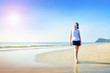 © Suriyo - Beautiful women walking on the beach see blue sky and sea on background