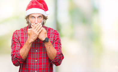 Canvas Print - Handsome hispanic man model wearing santa claus christmas over isolated background shocked covering mouth with hands for mistake. Secret concept.