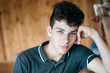 © Мар'ян Філь - A beautiful teenager sits at home and dreams of his future. The boy has very beautiful blue eyes, he smiles thoughtfully
