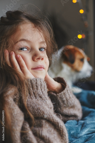 Fotografie, Obraz Portrait of a cute little smiling girl with jack russell terrier puppy behind