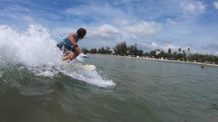 Wall Mural - Amateur surfer rides the ocean wave and falls