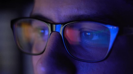 Man with Glasses Working in Office at Night