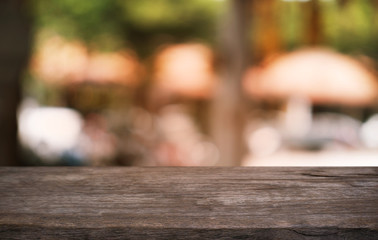 Empty dark wooden table in front of abstract blurred bokeh background of restaurant . can be used for display or montage your products.Mock up for space.