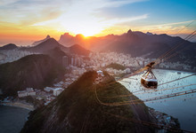 Aerial View Of Rio De Janeiro At Sunset With Urca And Sugar Loaf Cable Car And Corcovado Mountain  - Rio De Janeiro, Brazil