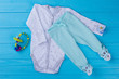 © margostock - Baby pajama and rattle toy.