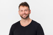 © lukas_zb - Happy, handsome young man in black smiling portrait against white background
