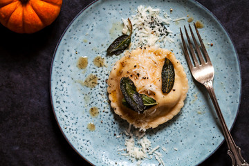 Wall Mural - Pumpkin and ricotta ravioli with crispy sage, burnt butter sauce and parmesan