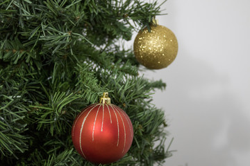 Green christmas tree with red and gold balls