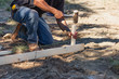 © Andy Dean - Worker Installing Stakes and Lumber Guides At Construction Site