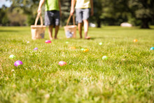 Easter Eggs Hunt. Blurred Silhouettes Of Children With Baskets In Hands. The Concept Of Family Fun At Easter.  Blurred Background. Cope Space For Your Text