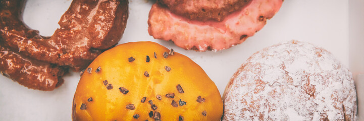 donuts box panorama banner. boston cream passion fruit doughnut, berry jelly filled berliner, glazed