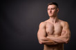 © Ranta Images - Handsome muscular fitness man shirtless with arms crossed thinking