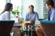 © ty - Team young professionals having casual discussion in office. Executives having friendly discussion during break.