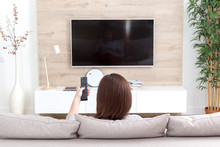 Young Woman Watching TV In The Room