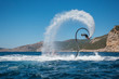 Flyboarding and seariding on the Sea near the mountain island. Water summer extreme sports.