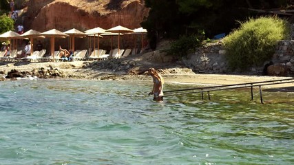 Wall Mural - joyful young girl swims in the sea