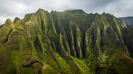 Rugged cliffs of the monumental Na Pali Coast, aerial shot from a helicopter, Kauai, Hawaii.